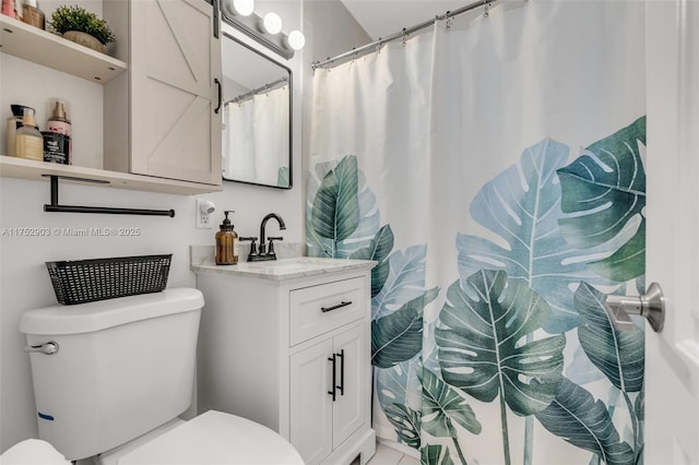 bathroom with curtained shower, vanity, and toilet