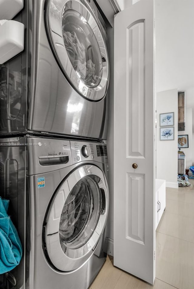 laundry area featuring laundry area and stacked washer / dryer