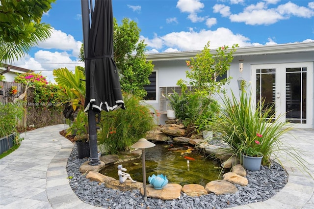 view of yard featuring french doors, a patio area, and fence