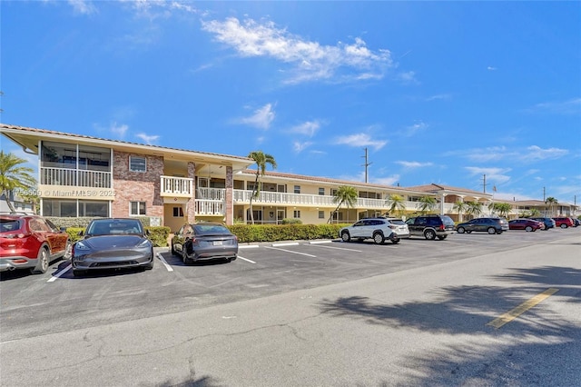 view of building exterior featuring uncovered parking