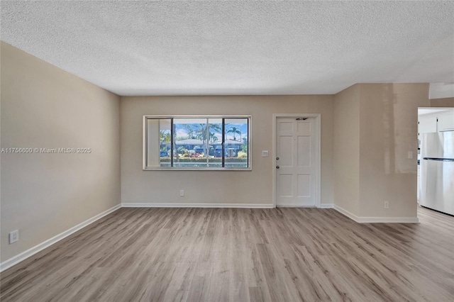 interior space featuring light wood-type flooring and baseboards