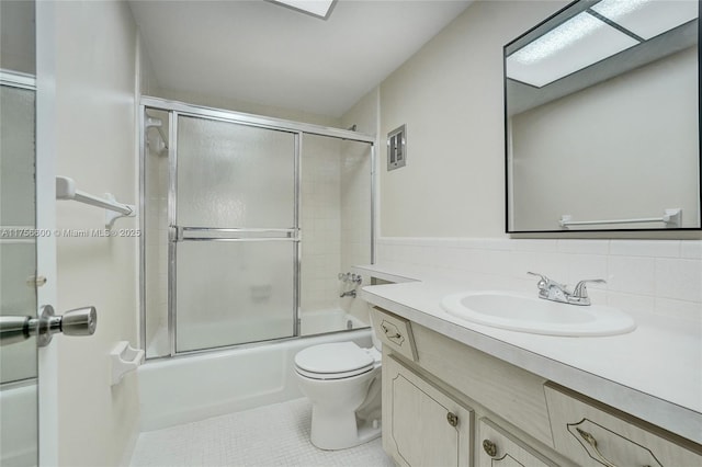 full bathroom featuring enclosed tub / shower combo, toilet, visible vents, vanity, and tile patterned floors