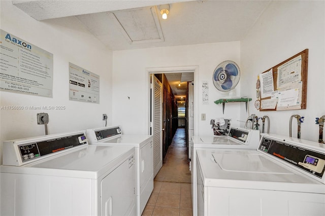 community laundry room with light tile patterned floors and washing machine and clothes dryer