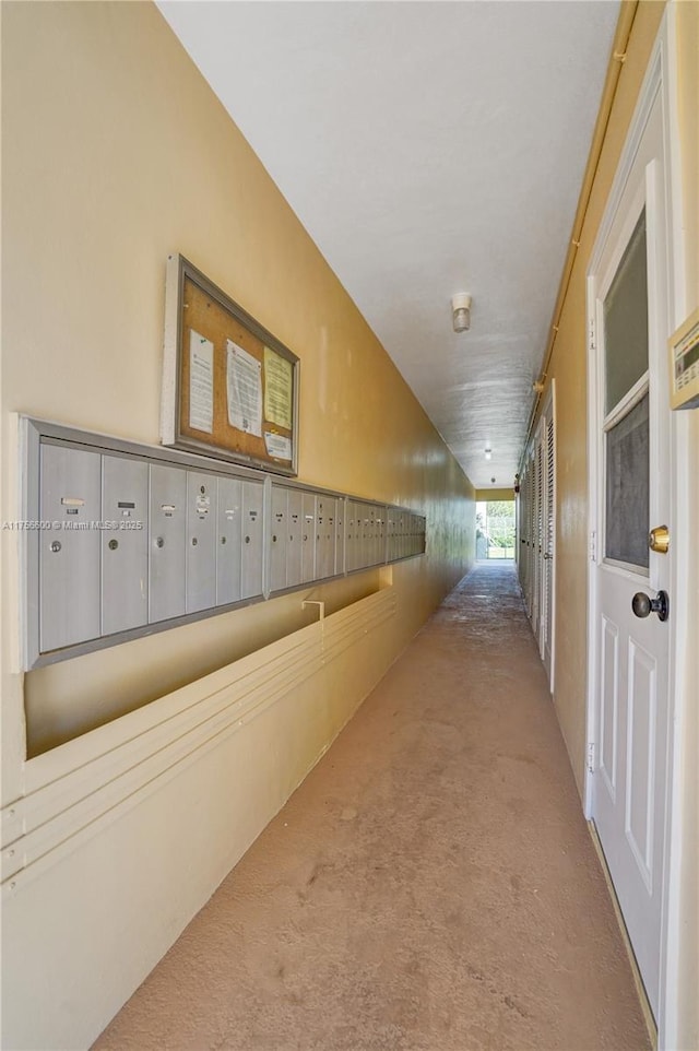 hallway with carpet and mail area