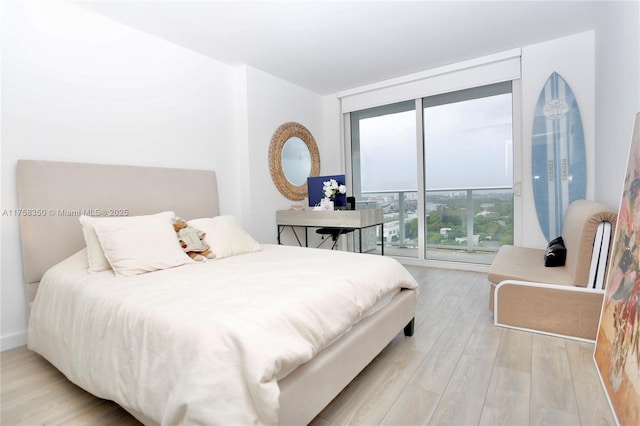 bedroom featuring light wood-style flooring