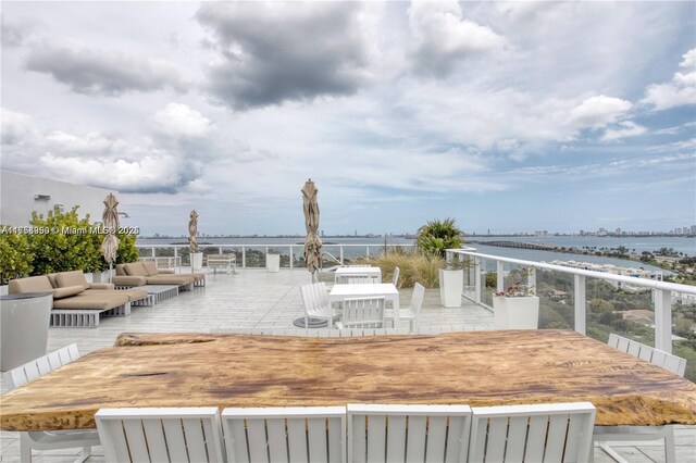 4250 Biscayne Blvd Unit 1512, Miami, FL 33137 - wooden terrace with a water view, an outdoor living space, and outdoor dining area