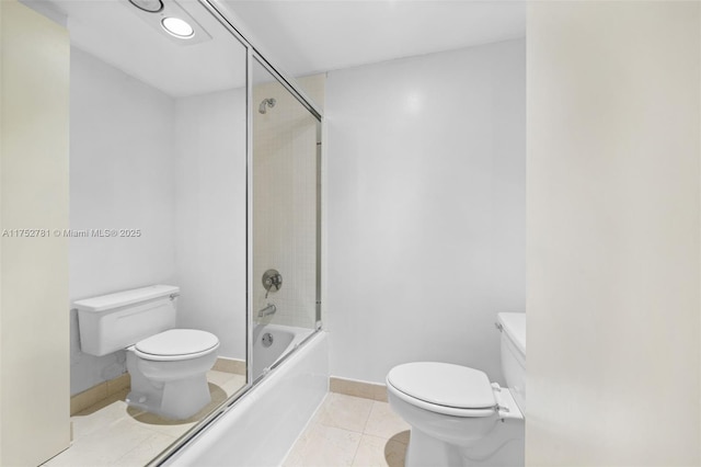 bathroom featuring enclosed tub / shower combo, baseboards, toilet, and tile patterned floors