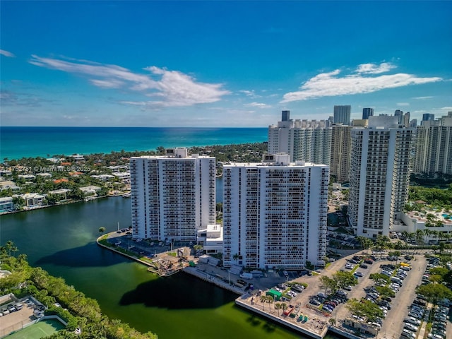 drone / aerial view featuring a view of city and a water view