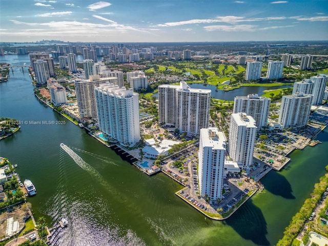 birds eye view of property with a water view and a city view