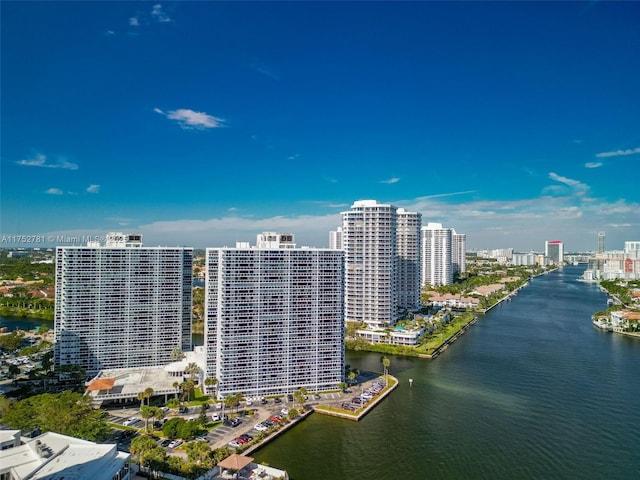 birds eye view of property featuring a city view and a water view