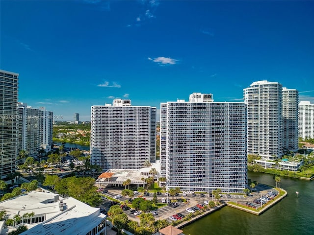 birds eye view of property featuring a water view and a city view