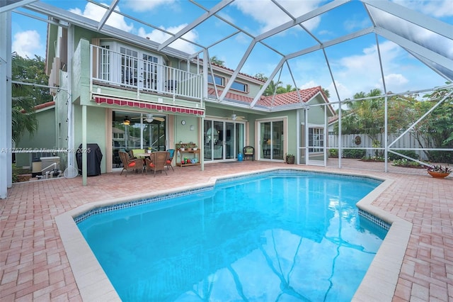 view of pool featuring a patio area, fence, a fenced in pool, and a lanai