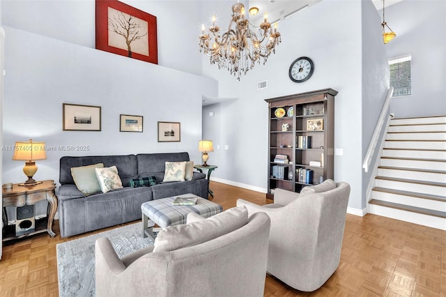 living room featuring visible vents, baseboards, stairway, and a high ceiling