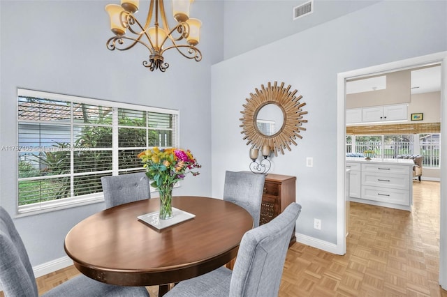 dining room with an inviting chandelier, baseboards, and visible vents