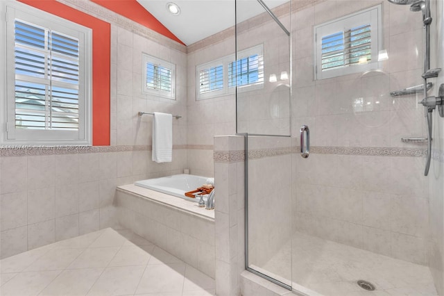 full bath with tile walls, lofted ceiling, a shower stall, a bath, and tile patterned floors