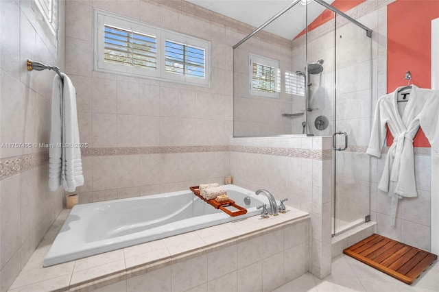 full bathroom with a stall shower, tile walls, and a bath