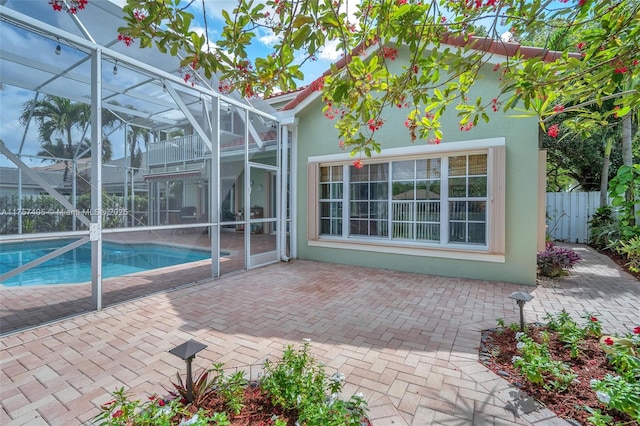 view of swimming pool featuring a fenced in pool, a lanai, a patio area, and fence