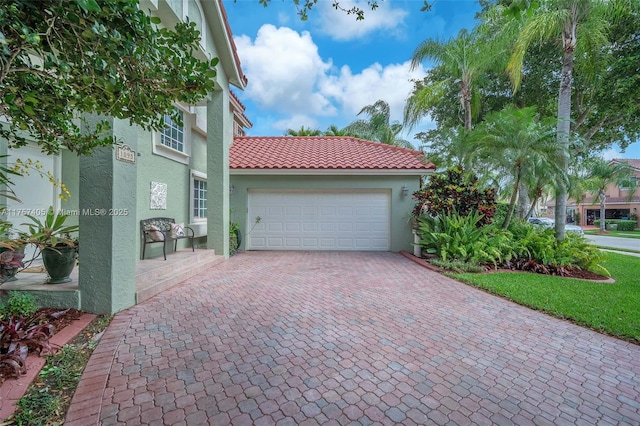 garage featuring decorative driveway