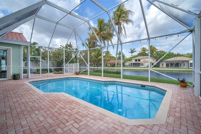 view of swimming pool with a fenced in pool, a patio, a lanai, a water view, and fence