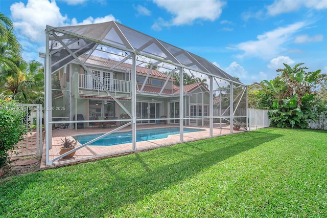 pool with a lanai, a patio area, a fenced backyard, and a yard