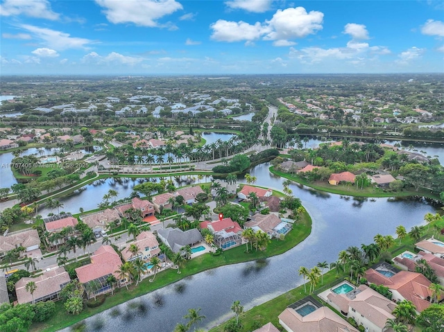 drone / aerial view with a water view and a residential view