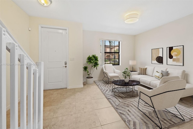 living room with light tile patterned floors and baseboards