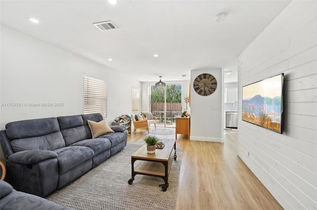 living room featuring recessed lighting, visible vents, and light wood-style floors