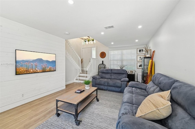 living room featuring visible vents, wood walls, stairs, recessed lighting, and wood finished floors