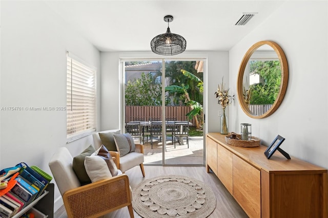 sitting room with visible vents and light wood-style floors