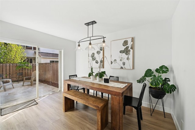 dining room featuring baseboards and wood finished floors