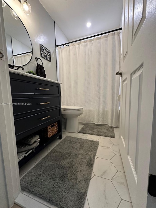 bathroom with vanity, toilet, and shower / bath combo