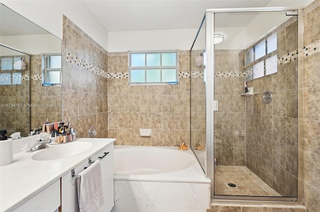 full bath featuring a shower stall, vanity, and a garden tub