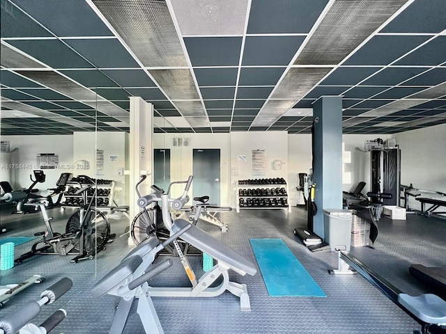 workout area featuring a paneled ceiling