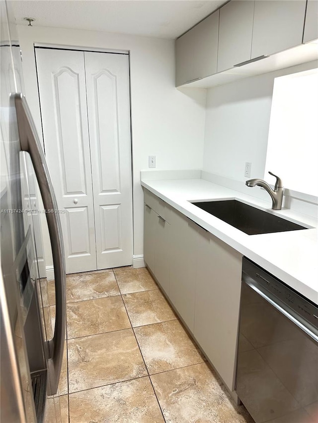 kitchen with light countertops, dishwasher, gray cabinets, modern cabinets, and a sink