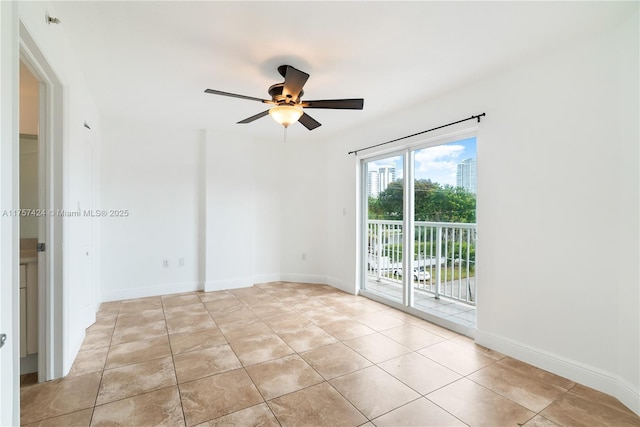 empty room featuring ceiling fan, baseboards, and light tile patterned floors