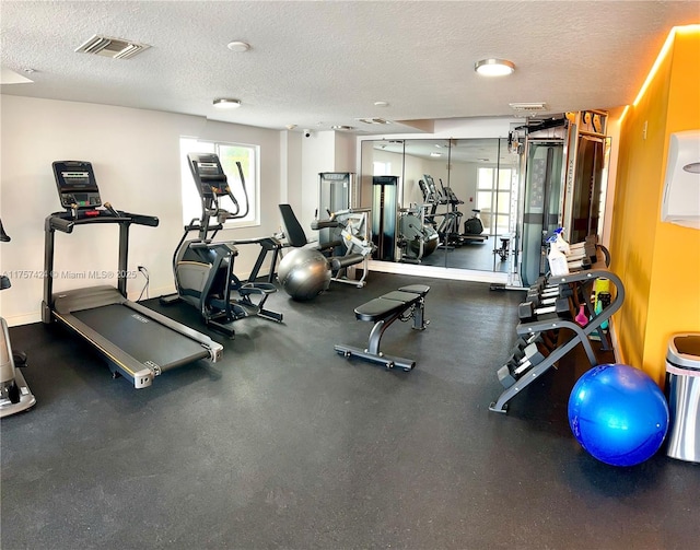 gym featuring a textured ceiling and visible vents