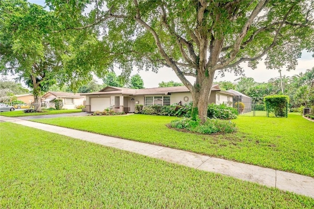 ranch-style house with a garage, driveway, a front lawn, and stucco siding