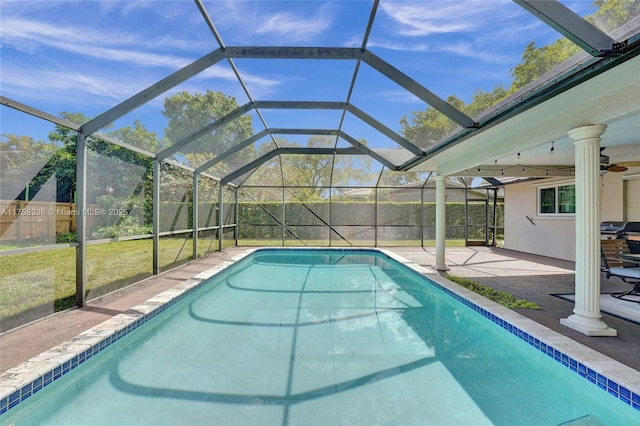 view of swimming pool featuring a lawn, a fenced in pool, ceiling fan, fence, and a patio area