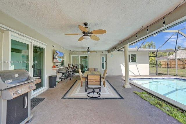 view of patio / terrace featuring a fenced in pool, fence, glass enclosure, area for grilling, and a ceiling fan