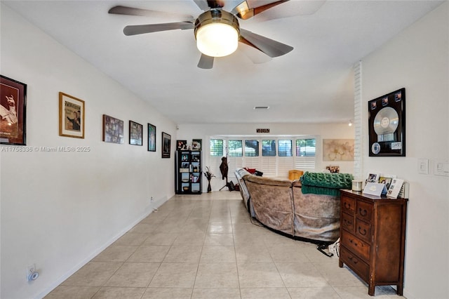 interior space with light tile patterned floors and a ceiling fan