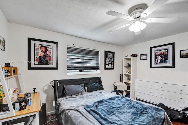 bedroom with ceiling fan and a textured ceiling