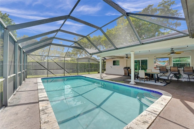 view of pool featuring a ceiling fan, a patio, glass enclosure, and a fenced in pool