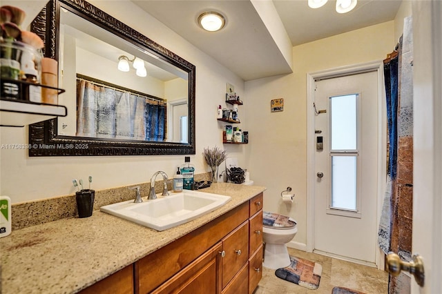 bathroom featuring toilet and vanity