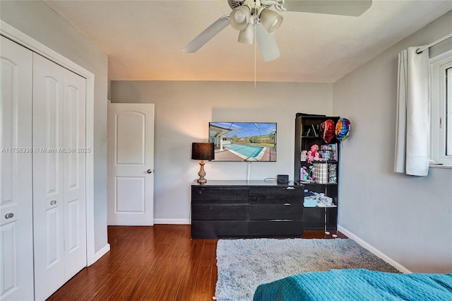 bedroom with a ceiling fan, a closet, baseboards, and wood finished floors