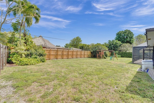 view of yard featuring a playground and a fenced backyard