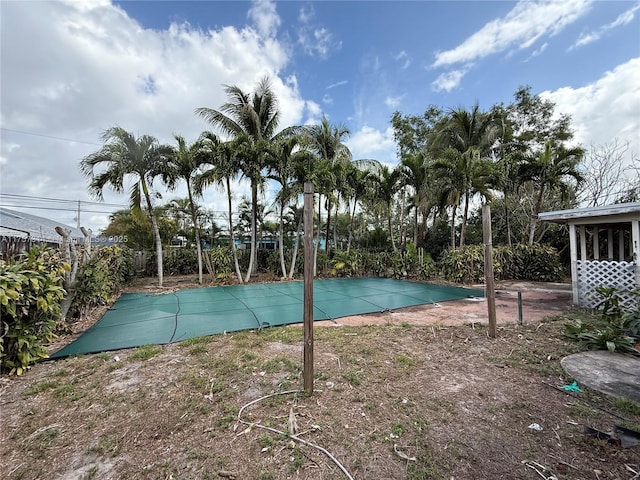 view of pool with fence and a covered pool