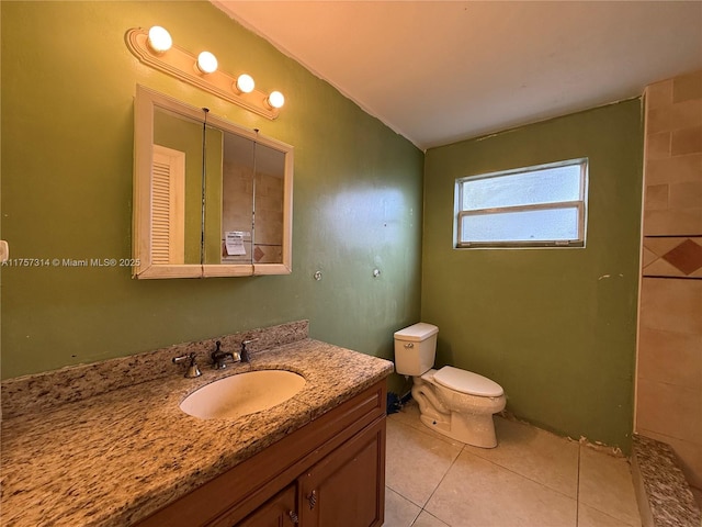 full bathroom featuring tile patterned flooring, vaulted ceiling, vanity, and toilet