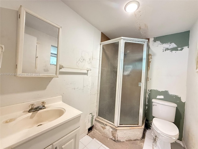 bathroom with a stall shower, tile patterned flooring, vanity, and toilet