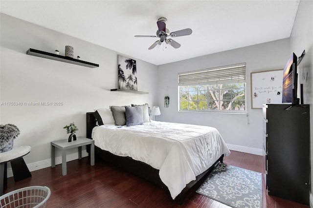 bedroom with ceiling fan, baseboards, and wood finished floors