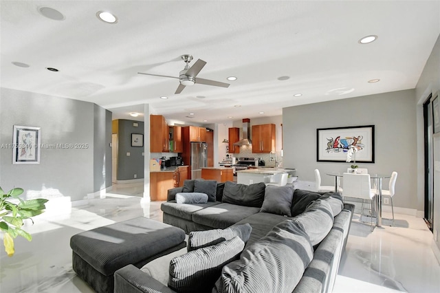 living area with baseboards, a ceiling fan, and recessed lighting